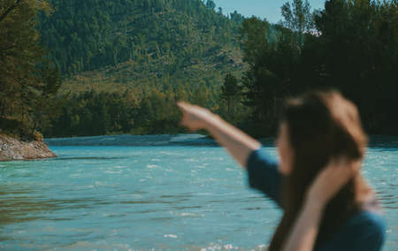 Summer landscape with mountains and river. woman in defocus