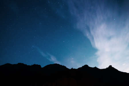 Starry sky over the mountains. Long exposure galaxy night shot.の写真素材