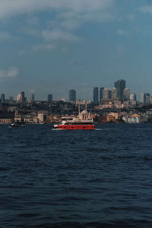 A passenger red motor ship sails on the Bosphorus Gulf in Istanbul.