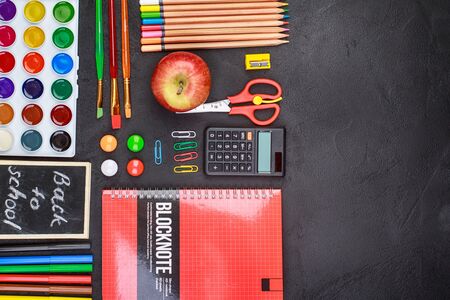 School supplies on black board background colorful back to school
