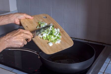 aged woman hands in process of cooking vegetables step by step recipe ratatouille natural lightの写真素材