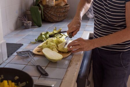aged woman hands in process of cooking vegetables step by step recipe ratatouille natural lightの写真素材