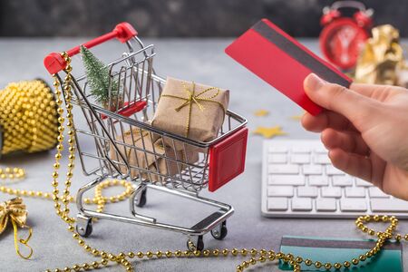 Small red shopping cart with keyboard for Internet online shopping concept christmas gifts. save time.の写真素材