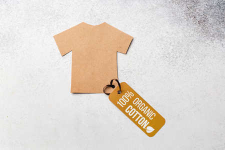 Organic cotton clothing concept with label. Paper craft t-shirt. Eco-clothingの写真素材