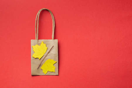 small paper bags with paper craft maple leaves autumn sale conceptの写真素材