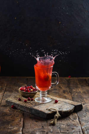 Autumn splash. creative concept. Nut is falling into the fruit drink. Splashing from a glassfulの写真素材