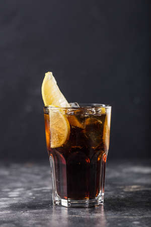 Refreshing alcohol cocktail Long Island Iced Tea in glass placed on table. High quality photoの写真素材