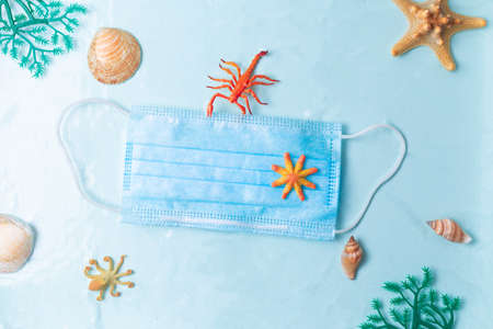Plastic waste pollution in the sea since coronavirus COVID-19 pandemic, face mask floating under...
