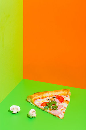 pizza with ham and mushrooms on paper green and orange background