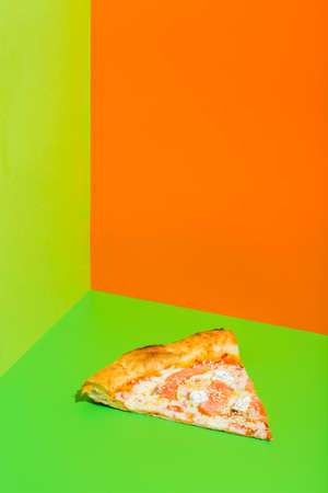 Pizza with Mozzarella cheese, salmon fish. Italian pizza on green paper backgroundの写真素材