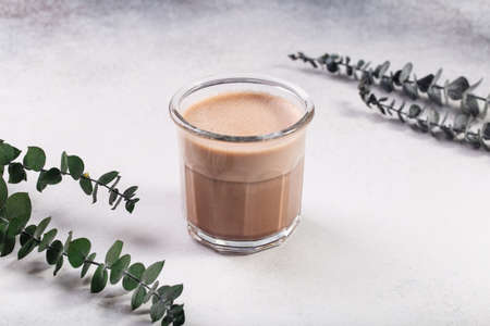 Raf coffee coffee steamed with cream eucalyptus behind on greyの写真素材