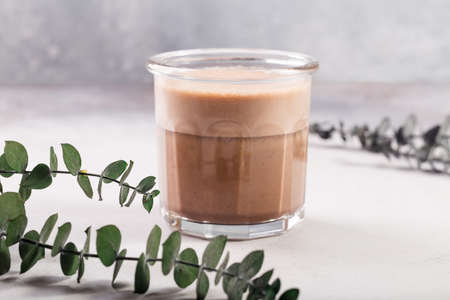 Raf coffee coffee steamed with cream eucalyptus behind on grey