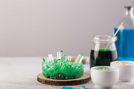 Green crystal grown by a child. Science is fun concept. Experiment with children at homeの写真素材