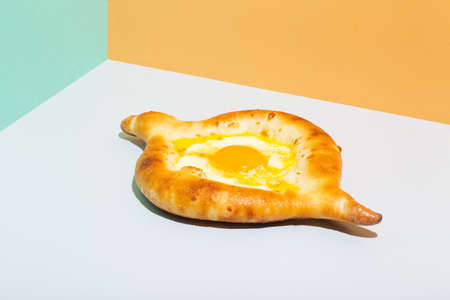 Closeup on caucasian flat bread adjarian khachapuri with egg on orange backgroundの写真素材