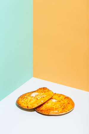 Uzbek national food Tandyr bread Lepeshka with cheese on blue background minimalistic style