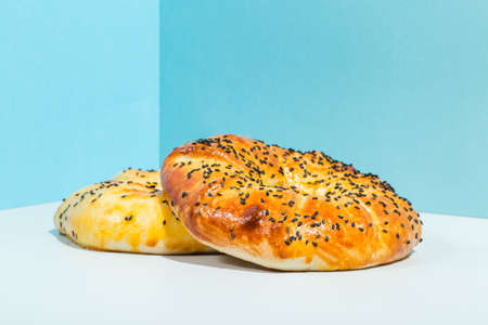 Uzbek national food Tandyr bread Lepeshka with cheese on blue background minimalistic styleの写真素材