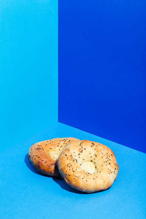 Uzbek national food Tandyr bread Lepeshka with cheese on blue background minimalistic styleの写真素材
