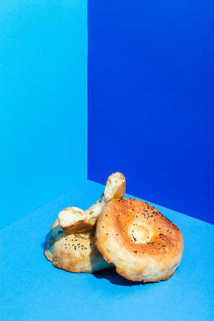 Uzbek national food Tandyr bread Lepeshka with cheese on blue background minimalistic styleの写真素材