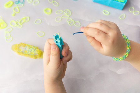Concept of making loom bracelets by kids blue and yellowの写真素材