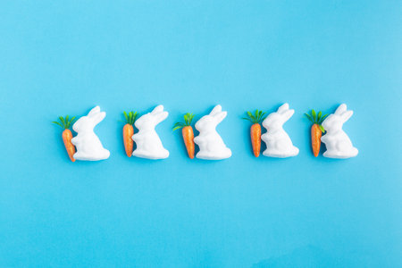 easter white rabbits ready to paint carrots conceptの写真素材