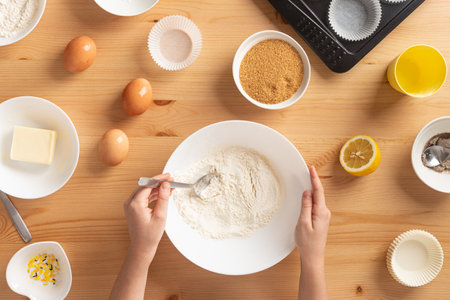 Girl is cooking muffins in the kitchen process concept ingredients simpleの写真素材