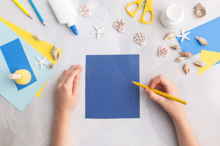 Paper bucket of shells summer idea for kids craft in kindergarten hands oceans dayの写真素材