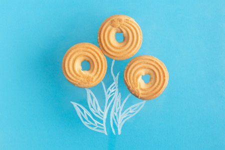 Round cookies with hole integrated in chalk drawing flowers creative concept flat layの写真素材