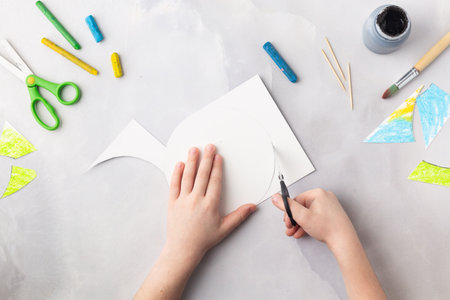 Globe in the night cut from paper and decorated with wax crayons, black paint and toothpick earth day concept kid's paper craft. High quality photoの写真素材