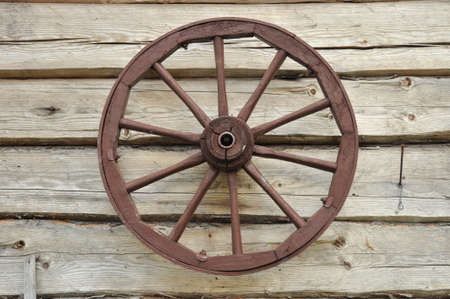 On the wall sees an old wooden wheel