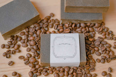 Natural handmade soap, aromatic cosmetic oil, coffee beans on rustic wooden backgroundの写真素材