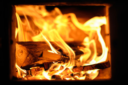 Fire in the fireplace, close up of firewood burning in the fireplaceの写真素材