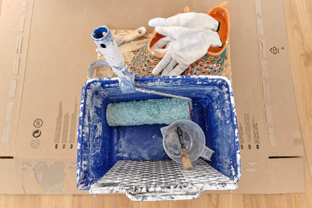 Blue plastic bucket with painter's tools on the background of the carton boxの写真素材