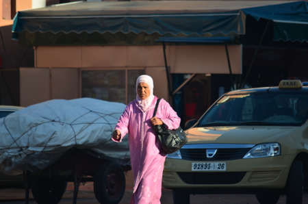 Marrakech, Morocco November 19, 2012. Woman with djellaba in the city of Marrakech.のeditorial素材
