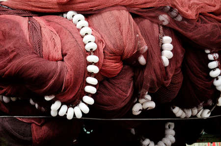 Pile of commercial fishing net with cords and floats as abstract background