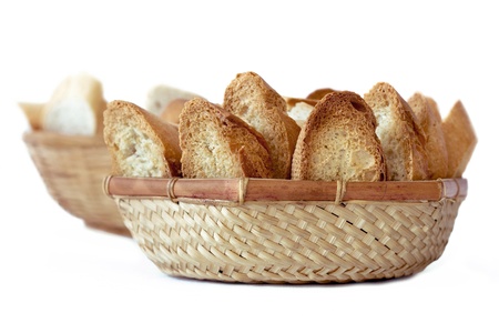 two baskets of bread, a toast and the other with normal bread on white backgroundの写真素材
