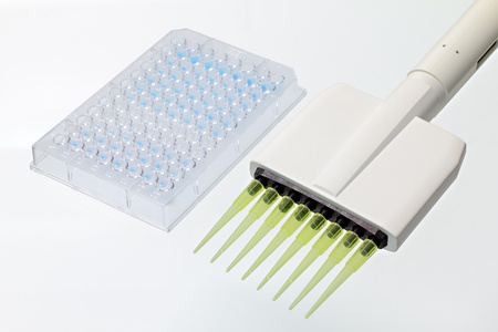 Collection of microplate with a multiple pipetter ready for sowing in the laboratory analysisの写真素材