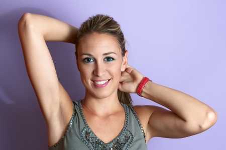 portrait of a beautiful smiling woman in a pink backgroundの写真素材