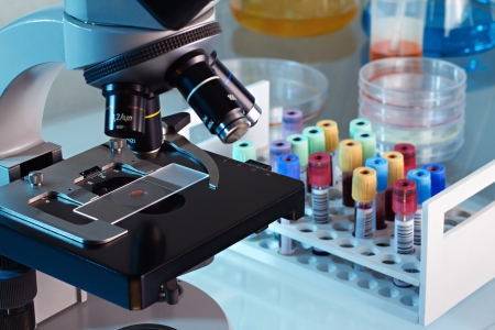 Workbench blood bank laboratory with a microscope and tubes with patient samplesの写真素材