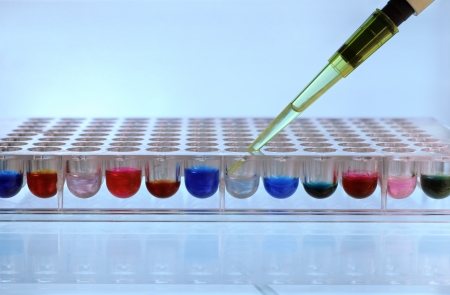Depositing pipette reagent in a 96 well plateの写真素材