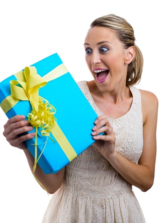 Surprised woman with a gift in white background の写真素材