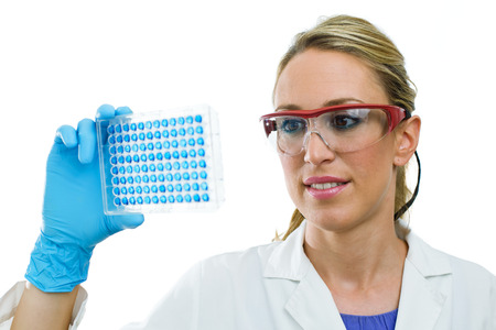 laboratory woman examining a 96 well microplate in handの写真素材