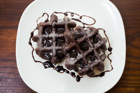 two chocolate black waffles in plateの写真素材