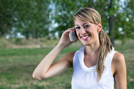 Portrait of a smiling woman talking on the phoneの写真素材