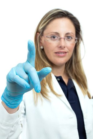 female doctor or pharmaceutical touching something with his finger isolated on a white background with copyspaceの写真素材