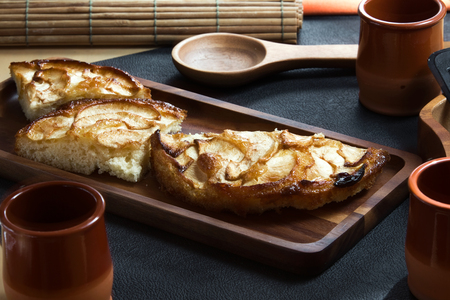 appetizing portion of apple cake on a dark background  portions of delicious apple pie fresh from the ovenの写真素材