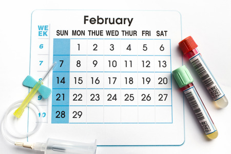 February 2016 planning calendar and blood samples in tubes  blood tubes and needle on the bottom of an appointment calendar of February 2016の写真素材