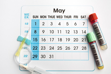 May 2016 planning calendar and blood samples in tubes  blood tubes and needle on the bottom of an appointment calendar of May 2016の写真素材