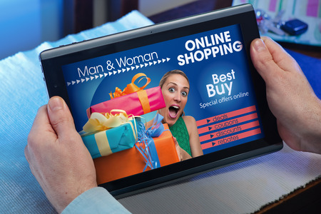 man searching website internet store to purchase online with your tablet in you home  hands of a man at a website with an announcement concept for online salesの写真素材