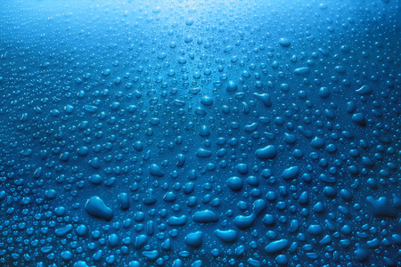 water drops splash in blue background / water drops backgroundの写真素材