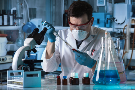 researcher holding pipette and tube for taking samples in micro / scientist pipetting sample of tube test in the research laboratoryの写真素材